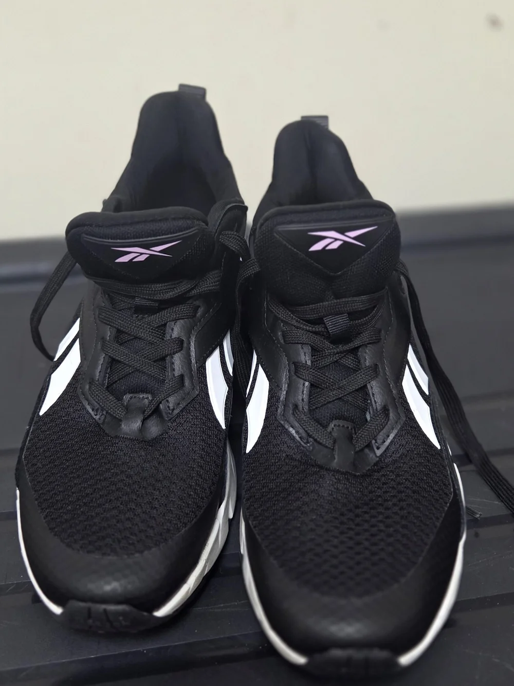 Reebok Black Athletic Sneakers with White Stripes and Pink Logo